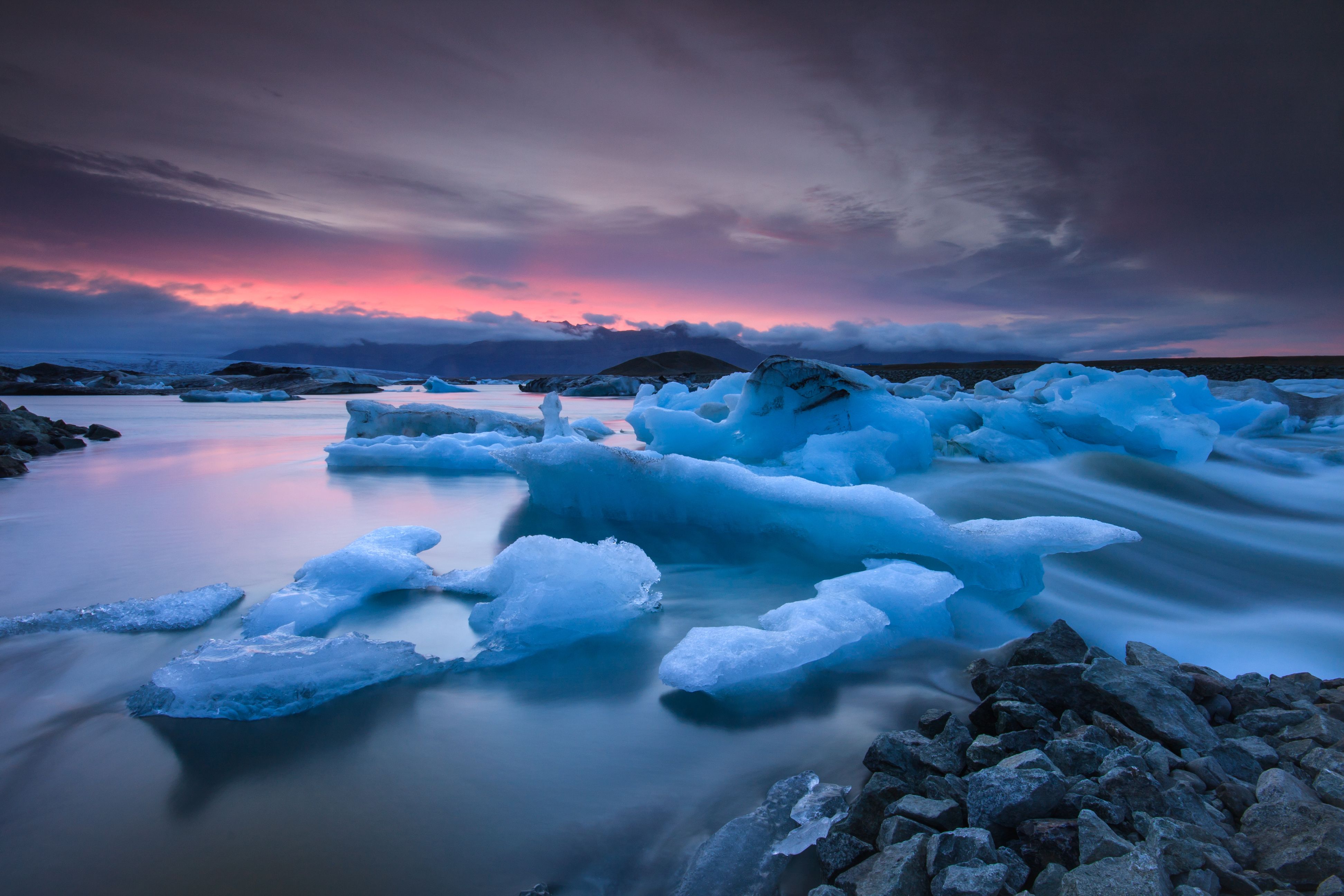 Icebergs floating in Jokulsarlon glacier lake at sunset