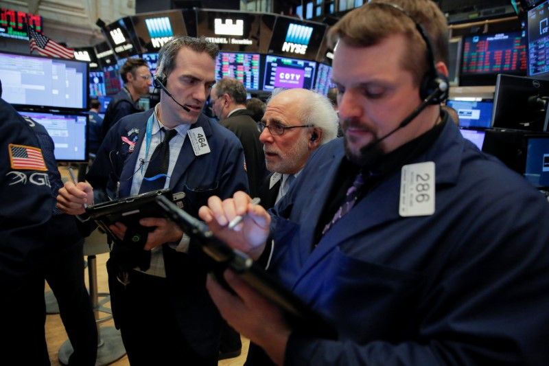 Traders work on the floor at the New York Stock Exchange (NYSE) in Manhattan, New York